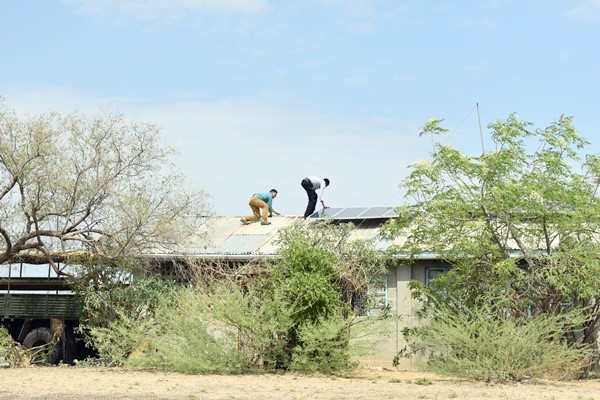 Figure 11 Students evaluating the conditions of the PV array at the roof of the Health Clinic