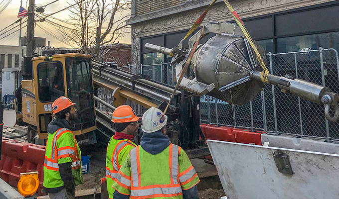 Rigging of borehole reamer into place with single lane closure to support continuity of local businesses Rigging of borehole reamer into place with single lane closure