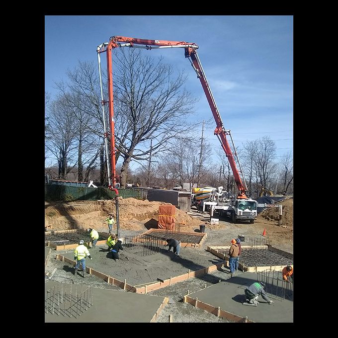 Placement of base of concrete pier foundations using concrete pump truck