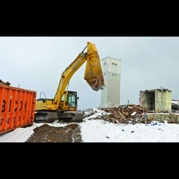 Excavator picking through the metal at the former Rome Cable site.
