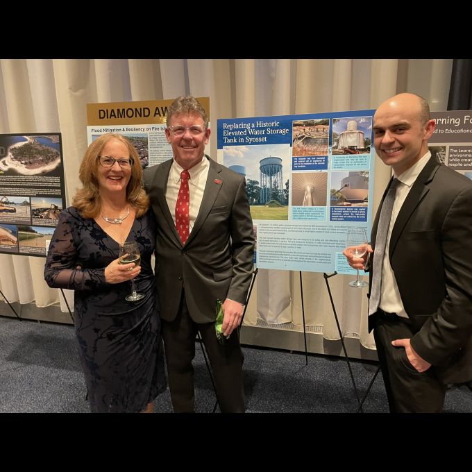 Peter J. Connell, P.E. of D&B celebrates the “Replacement of 1.5 MG Syosset Elevated Tank” winning project with Peter Logan of Jericho Water District and his wife, Diane.