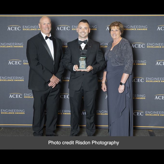 Thomas P. Schaefer, P.E., D&B Senior Associate (center) accepts the Recognition Engineering Excellence Award (EEA) on behalf of D&B Engineers and Architects. Credit: Risdon Photography